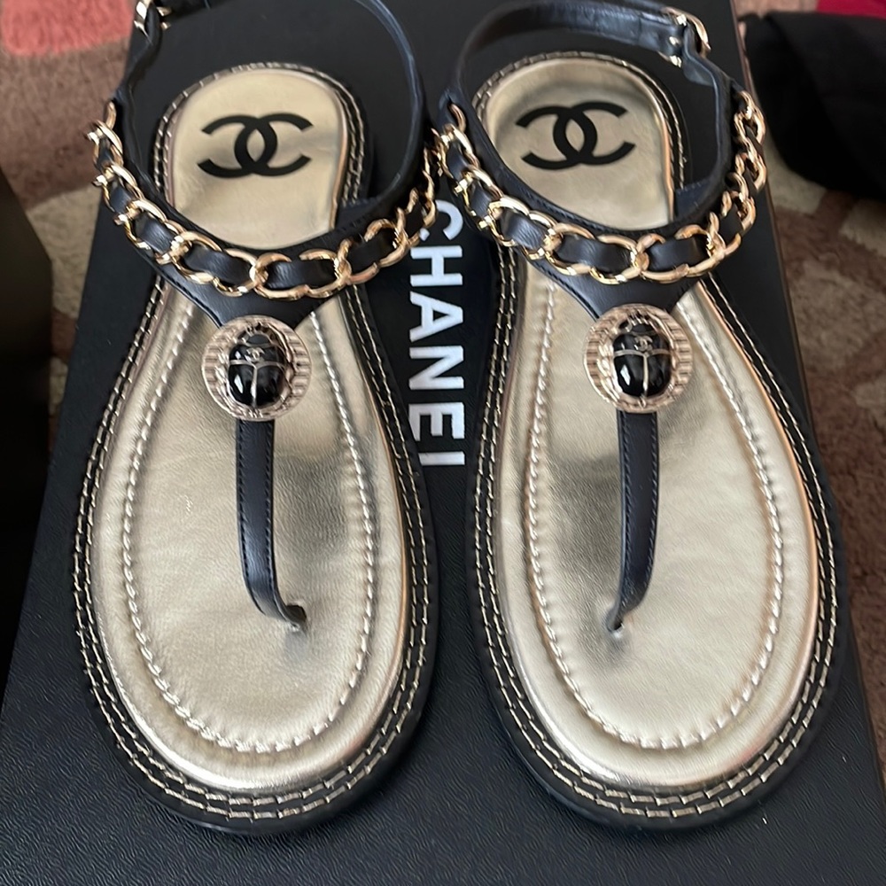 Chanel black scarab leather sandal.